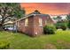 Back view of a red brick house, with a large tree in the background at 757 Longfellow Rd, Charleston, SC 29407