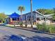Outdoor dining area with a covered patio, set with tables and chairs, next to a modern restaurant building at 757 Longfellow Rd, Charleston, SC 29407