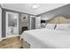 Relaxing bedroom with ensuite bathroom, ceiling fan, and wood floors at 7911 Windfern Ct # 1502, North Charleston, SC 29418