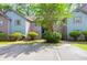 Exterior view of units displaying landscaping with a tree in front of the building at 7911 Windfern Ct # 1502, North Charleston, SC 29418