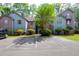 Exterior of the complex displaying parking spots in front of the units and well-maintained landscaping at 7911 Windfern Ct # 1502, North Charleston, SC 29418