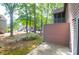 A view of the side of the house showcasing the patio and natural landscape of trees and greenery at 7911 Windfern Ct # 1502, North Charleston, SC 29418