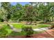 Inviting green space with walking paths, benches, and mature trees, creating a serene outdoor retreat at 7911 Windfern Ct # 1502, North Charleston, SC 29418