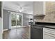Bright kitchen with black countertops and stainless steel dishwasher, along with a view to the outside at 7911 Windfern Ct # 1502, North Charleston, SC 29418