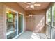 A covered patio features a ceiling fan, storage shelves, and a sliding glass door leading indoors at 7911 Windfern Ct # 1502, North Charleston, SC 29418