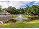 Relaxing pond with fountain and community pool in the background, perfect for a tranquil escape at 7911 Windfern Ct # 1502, North Charleston, SC 29418