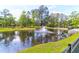 Picturesque pond with a fountain surrounded by lush green grass and various trees in the community at 7911 Windfern Ct # 1502, North Charleston, SC 29418
