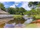 Scenic pond view with a fountain, complemented by lush greenery and the building's architecture at 7911 Windfern Ct # 1502, North Charleston, SC 29418