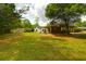 Spacious backyard with lush lawn and mature trees providing shade at 809 N Magnolia St, Summerville, SC 29483
