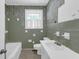 Retro bathroom featuring green tile, soaking tub, and vanity at 809 N Magnolia St, Summerville, SC 29483