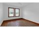 Bedroom with hardwood floors and natural light from two windows at 809 N Magnolia St, Summerville, SC 29483