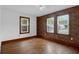 Bedroom features natural light from windows and a brick accent wall at 809 N Magnolia St, Summerville, SC 29483