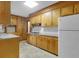 Traditional kitchen featuring wood cabinets, stone counters, and updated backsplash at 809 N Magnolia St, Summerville, SC 29483