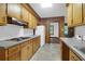 Kitchen featuring wood cabinetry, stone counters, and stainless vent hood at 809 N Magnolia St, Summerville, SC 29483