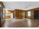 Living room with view to kitchen and wood paneling at 809 N Magnolia St, Summerville, SC 29483