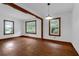 Bright room featuring hardwood floors, white walls and lots of natural light, ideal for a welcoming living space at 809 N Magnolia St, Summerville, SC 29483