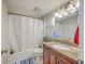 Bathroom features a granite countertop, shower-tub combo, and wooden cabinets at 811 Reserve Way, Summerville, SC 29485
