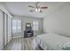 Cozy bedroom with ceiling fan, hardwood floors, and large window with plantation shutters at 811 Reserve Way, Summerville, SC 29485