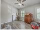 Bedroom featuring hardwood floors, ceiling fan, a window, and wood dresser at 811 Reserve Way, Summerville, SC 29485