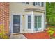 Close up of house featuring welcoming front door, bay window, and lush mulch landscaping at 811 Reserve Way, Summerville, SC 29485