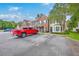 Street view of townhomes with a red truck in the foreground and visible unit numbers at 811 Reserve Way, Summerville, SC 29485