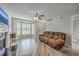 Bright living room with a fireplace, ceiling fan, and laminate wood flooring at 811 Reserve Way, Summerville, SC 29485