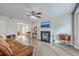Comfortable living room featuring a fireplace, ceiling fan, and modern flooring at 811 Reserve Way, Summerville, SC 29485