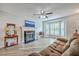 Cozy living room with a fireplace, bay window, and a comfortable brown couch at 811 Reserve Way, Summerville, SC 29485