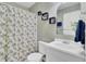 Stylish bathroom with a unique mirror, decorative shelves, and a shower/tub combo at 815 Temple Rd # B, Ladson, SC 29456