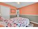 Colorful bedroom with floral bedding, closet, and hardwood floors at 815 Temple Rd # B, Ladson, SC 29456