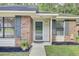 Inviting front entrance featuring a brick facade, blue shutters, and a 'Welcome' wreath on the glass door at 815 Temple Rd # B, Ladson, SC 29456