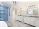 Spacious bathroom featuring double vanities with marble countertops, a glass shower with blue herringbone tiling at 83 Avondale Ave, Charleston, SC 29407