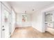 Dining room boasts wood floors, and a stylish light fixture next to the kitchen entrance at 83 Avondale Ave, Charleston, SC 29407