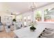 Elegant dining area with a white marble table and a view into the sunlit living space at 83 Avondale Ave, Charleston, SC 29407