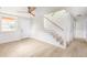 Bright entryway features wood floors, stairs with cable railing, and a modern ceiling fan at 83 Avondale Ave, Charleston, SC 29407