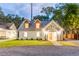 Inviting front exterior view of a home at twilight, beautifully lit and landscaped at 83 Avondale Ave, Charleston, SC 29407