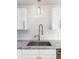 Close up of kitchen sink with white cabinets, subway tile backsplash, and granite countertops at 83 Avondale Ave, Charleston, SC 29407