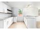 Bright kitchen features white cabinets, subway tile backsplash, granite countertops, and wood floors at 83 Avondale Ave, Charleston, SC 29407