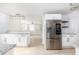 Renovated kitchen with stainless steel appliances, granite counters, white cabinets, and a breakfast bar at 83 Avondale Ave, Charleston, SC 29407