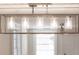 Modern light fixture hanging in a room with white walls and a bright open space at 83 Avondale Ave, Charleston, SC 29407