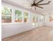 Bright living room with wood floors, white walls, large windows, and a ceiling fan at 83 Avondale Ave, Charleston, SC 29407