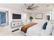 Stylishly staged bedroom with hardwood floors, a ceiling fan, and a view into the en suite bath at 83 Avondale Ave, Charleston, SC 29407