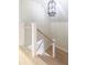 Modern staircase with wood treads, white posts and risers, and sleek cable railings at 83 Avondale Ave, Charleston, SC 29407