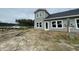 Backyard exterior view of a new two-story home with gray siding, black roof, and white trim at 857 Descartes St, Summerville, SC 29486