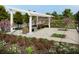 A beautiful outdoor pergola provides a relaxing space surrounded by flowers and lush greenery at 857 Descartes St, Summerville, SC 29486