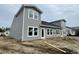 Side exterior view of a new two-story home with gray siding, black roof, and white trim at 857 Descartes St, Summerville, SC 29486