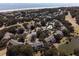 Overhead community aerial showcasing lush landscaping, pool, and tennis courts at 9 Fairway Dunes Ln, Isle of Palms, SC 29451