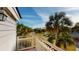 Balcony with palm tree view of the neighborhood and blue skies at 9 Fairway Dunes Ln, Isle of Palms, SC 29451