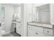 Bright bathroom with a separate vanity area and granite countertops at 9 Fairway Dunes Ln, Isle of Palms, SC 29451
