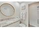 Bathroom featuring a round mirror and a shower with a glass door at 9 Fairway Dunes Ln, Isle of Palms, SC 29451